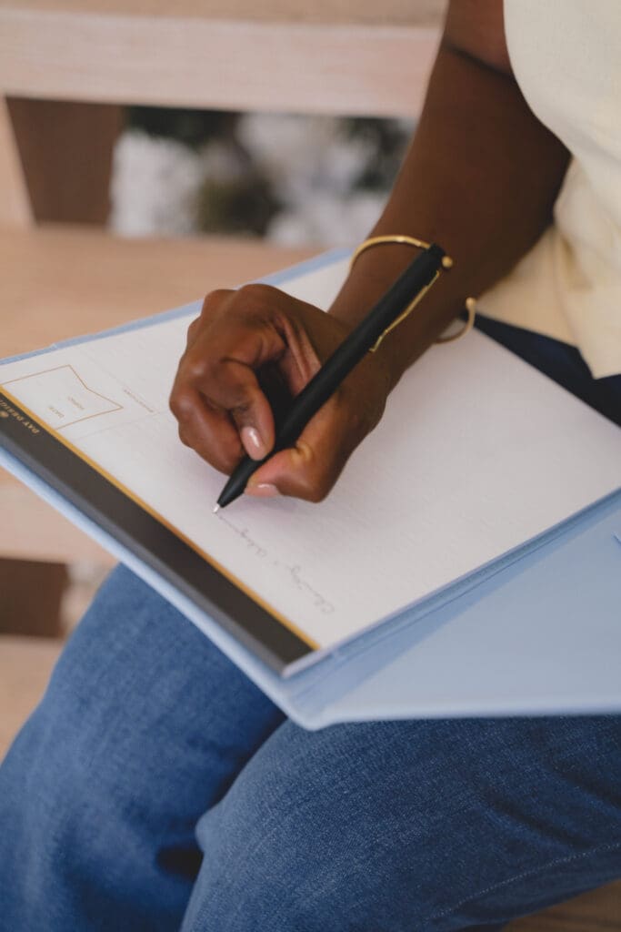 Image of career coach writing steps to land new career in 2026