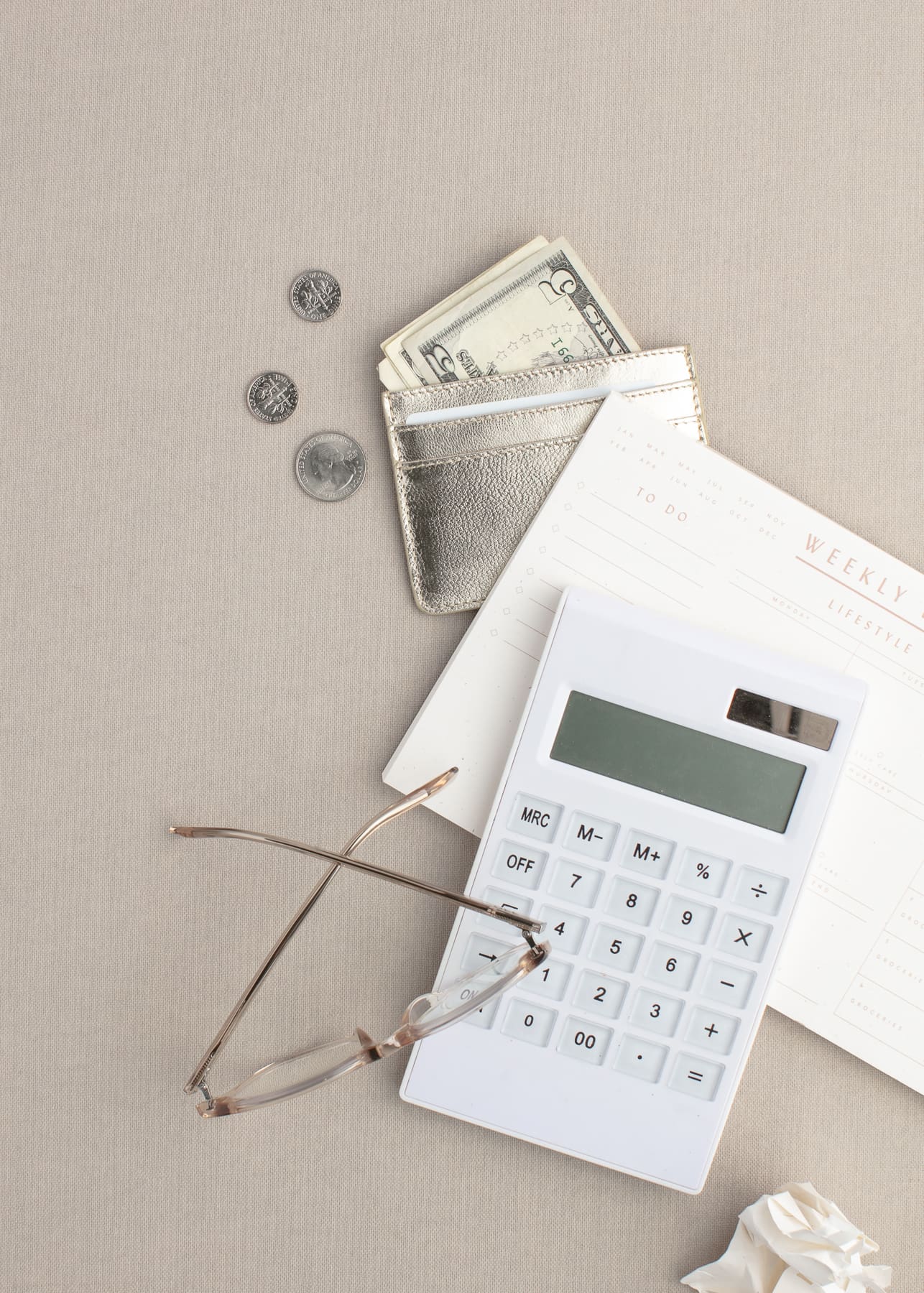 White calculator and money to show wealth